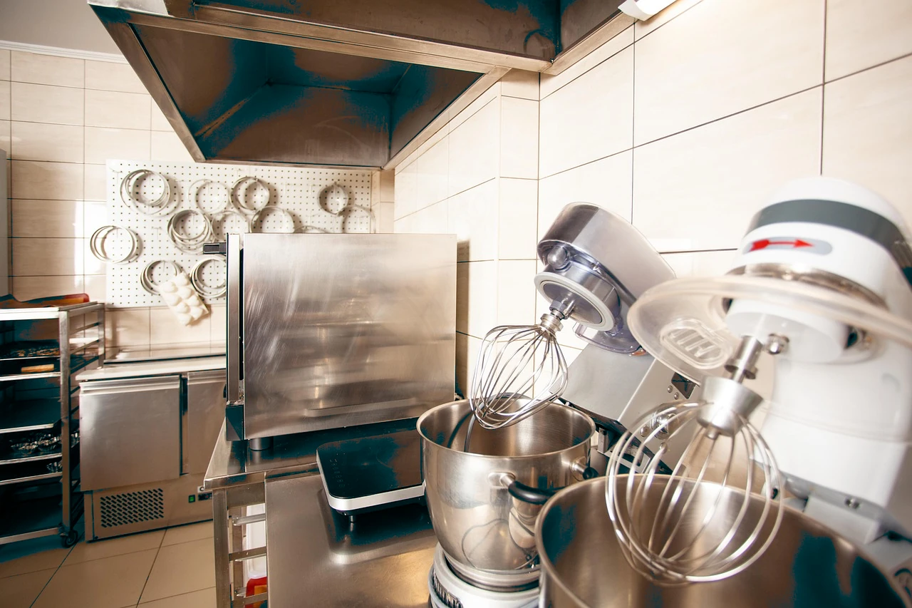 Stainless extract canopies over a commercial kitchen line