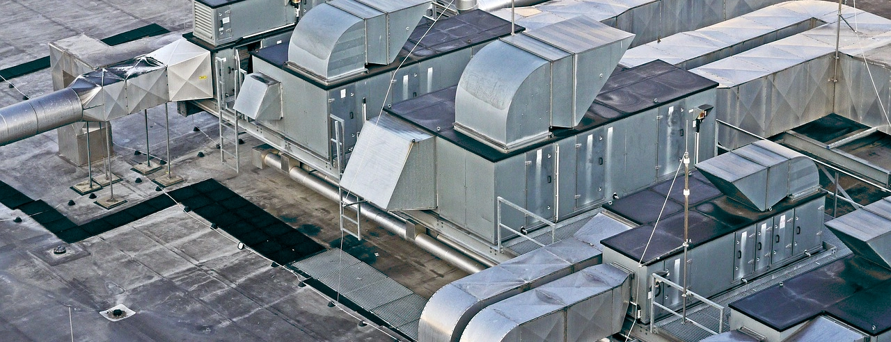 Rooftop air-handling plant and galvanised ductwork on a flat roof